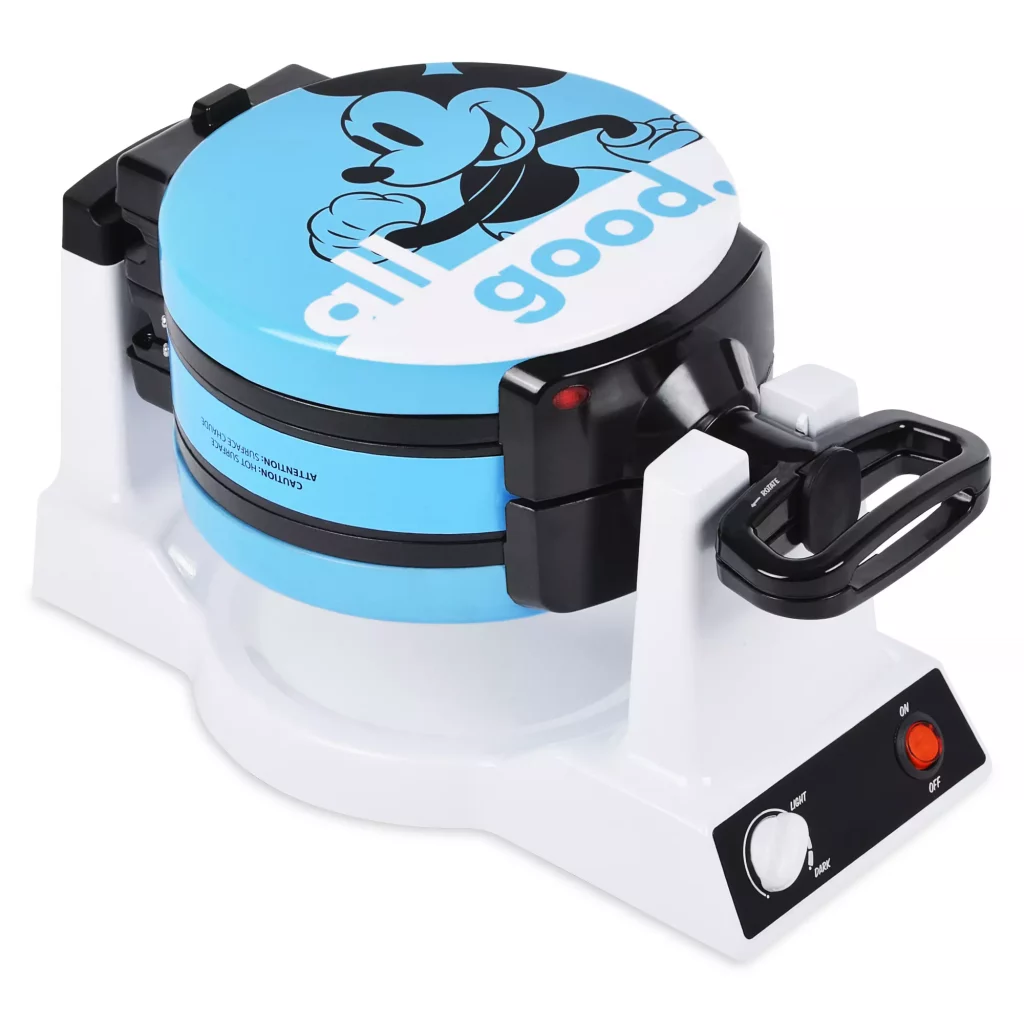 A blue waffle maker with Mickey Mouse on the front, with the phrase "All good" on it 