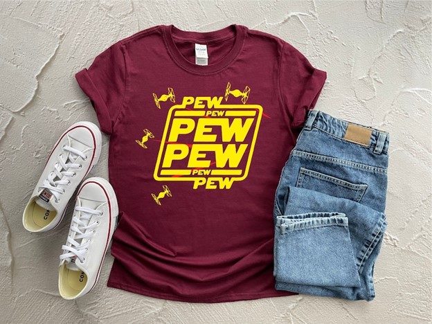 A maroon t-shirt with Yellow text that says Pew Pew
