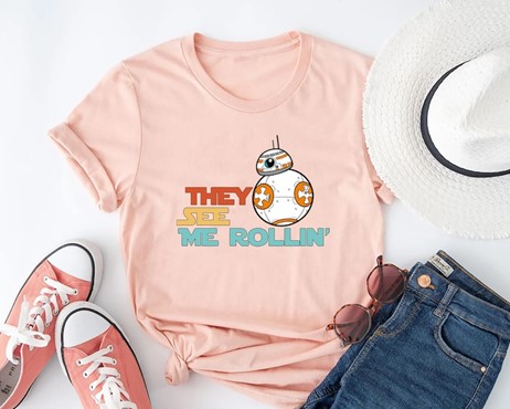 A pink t-shirt with BB8 next to the text "They see me rollin"