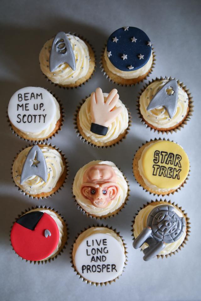 Decorated cupcakes with iconic Star Trek phrases, the SS Enterprise, uniforms, and Quark 